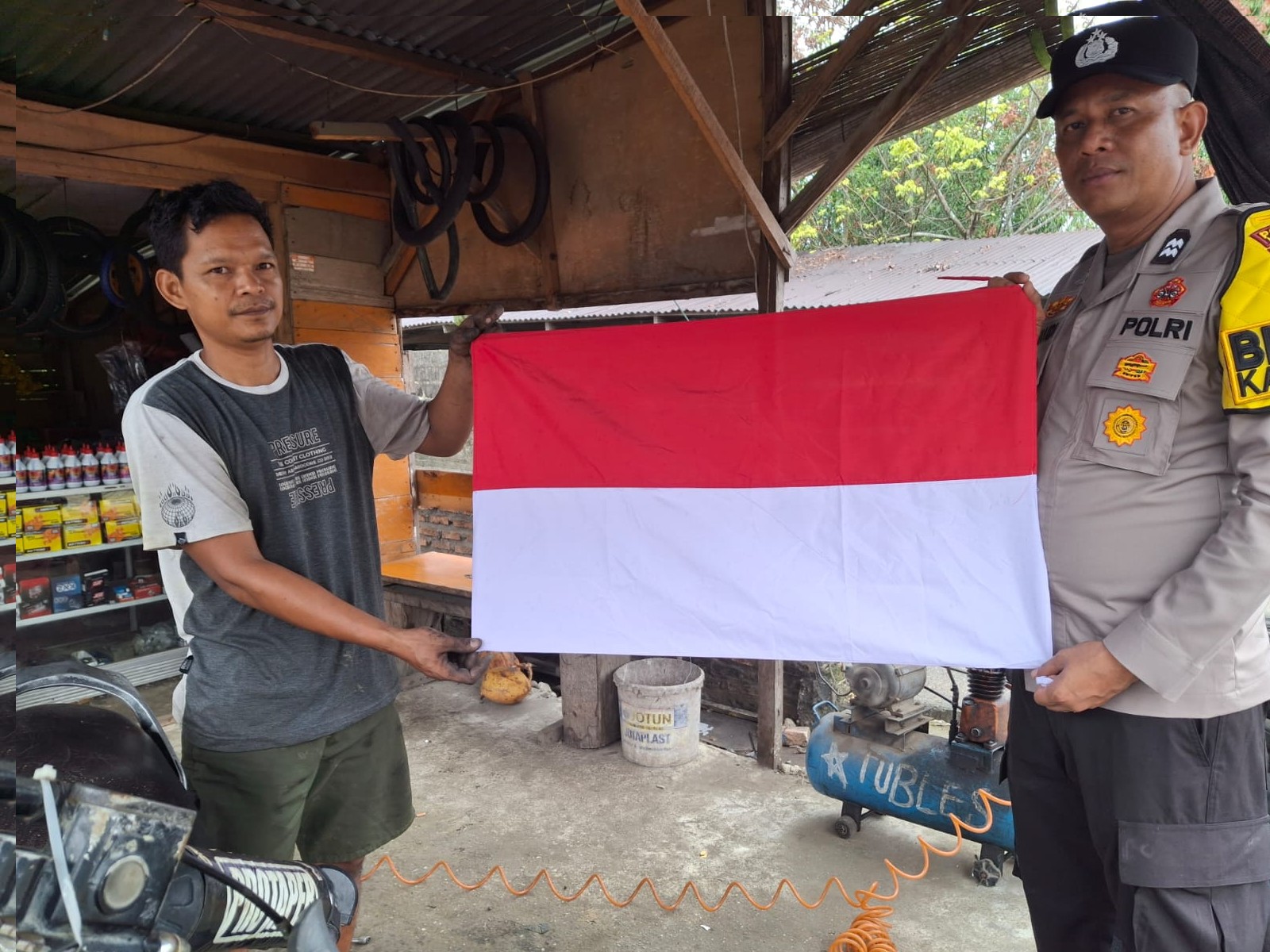 Sambut HUT RI ke-81, Polsek Kampar Kiri Bagikan dan Pasangkan Bendera Merah Putih di Rumah Warga